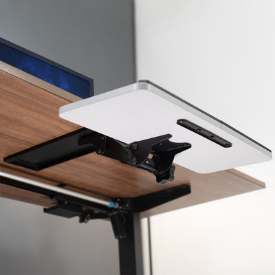 Fully furnished modern office space with a clamp-on rotating keyboard tray.