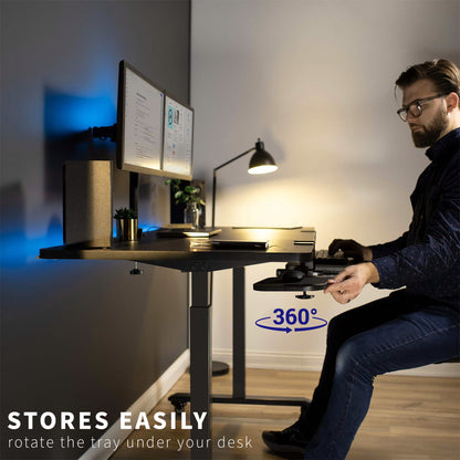 Man at an ergonomic desk with a swiveling mouse tray for easy storage.