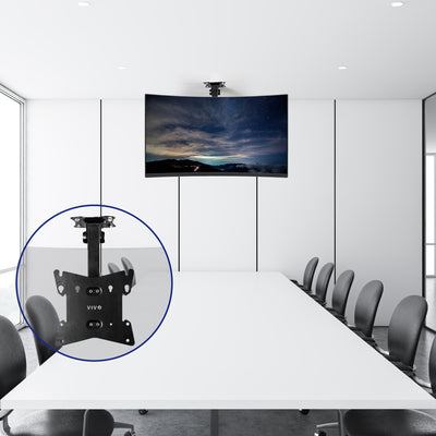 Flip down the TV mount supporting a large curved monitor in an office conference room.