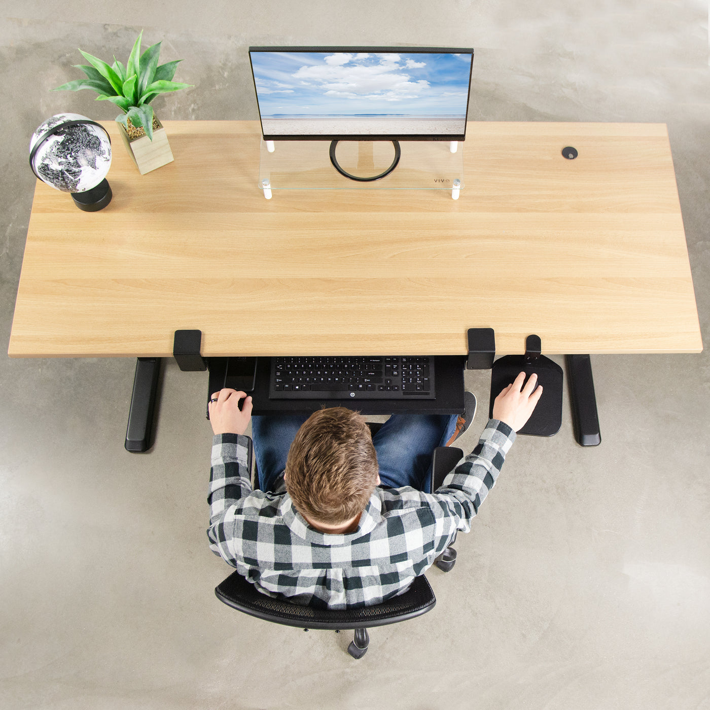 Clean, modern, and spacious desktop with under-desk keyboard and mouse pad trays. 