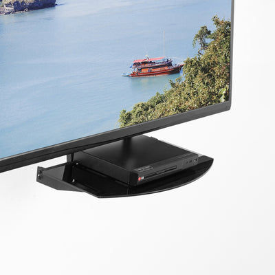 VESA mounts an attachable shelf supporting a streaming device below a TV.