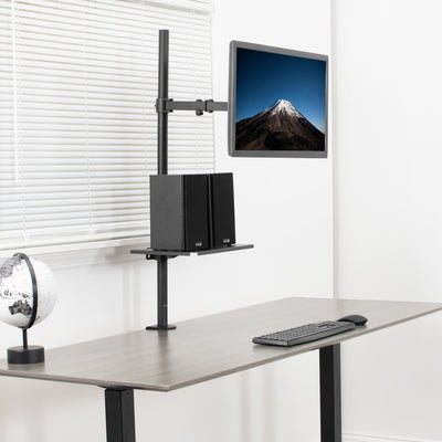 Extra tall pole with a shelf elevating two speakers under a monitor as a desk.