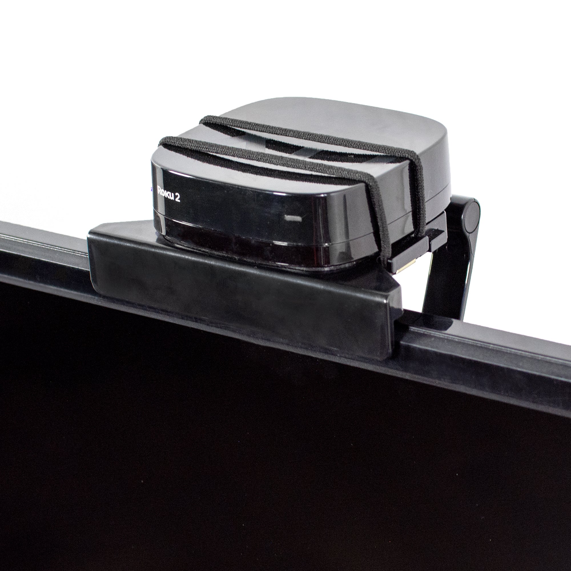 Sturdy TV mount clip for convenient storage of media box streaming devices.