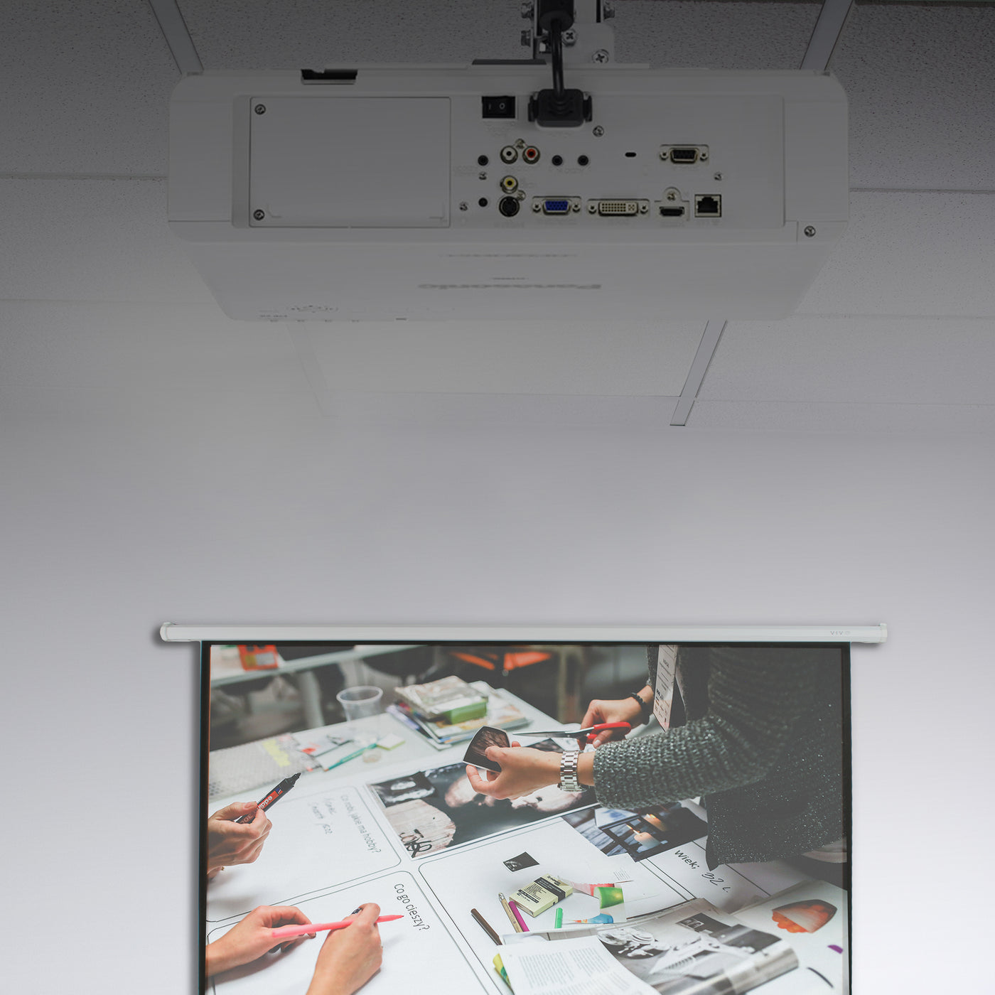 Subtel ceiling panel projector mount projecting an image onto a screen.