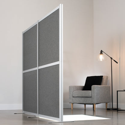 Sleek divider panels acting like a wall with a chair in the corner of the room.