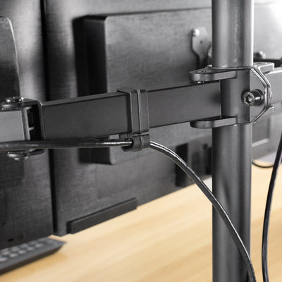 Cable clips on the back of a monitor mount.