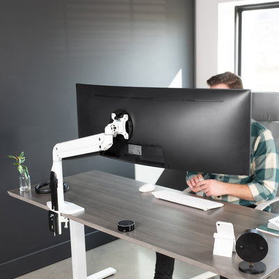 Sturdy height adjustable pneumatic arm single ultrawide monitor ergonomic desk mount for office workstation.