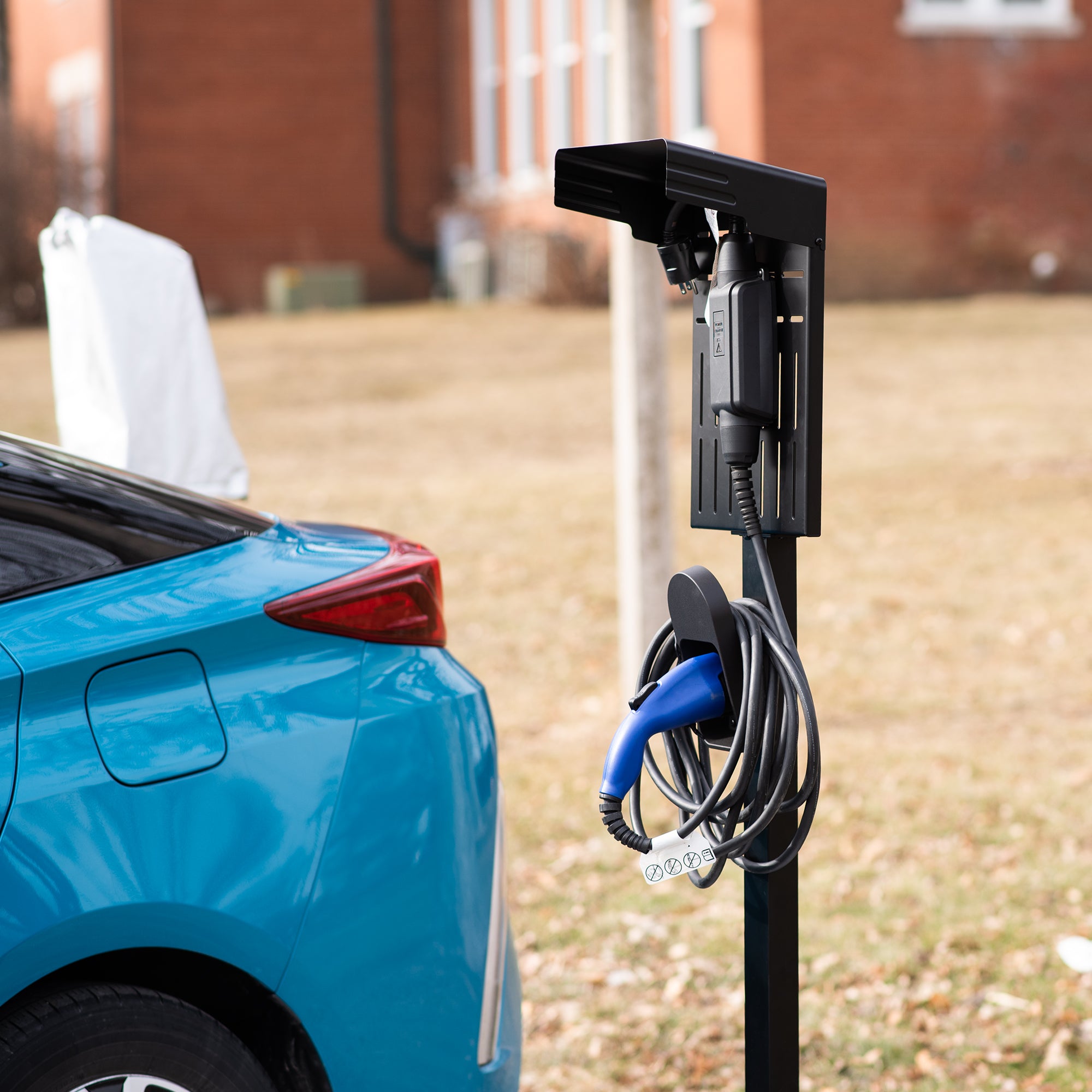 Electric Vehicle charging station with a car getting ready to charge.