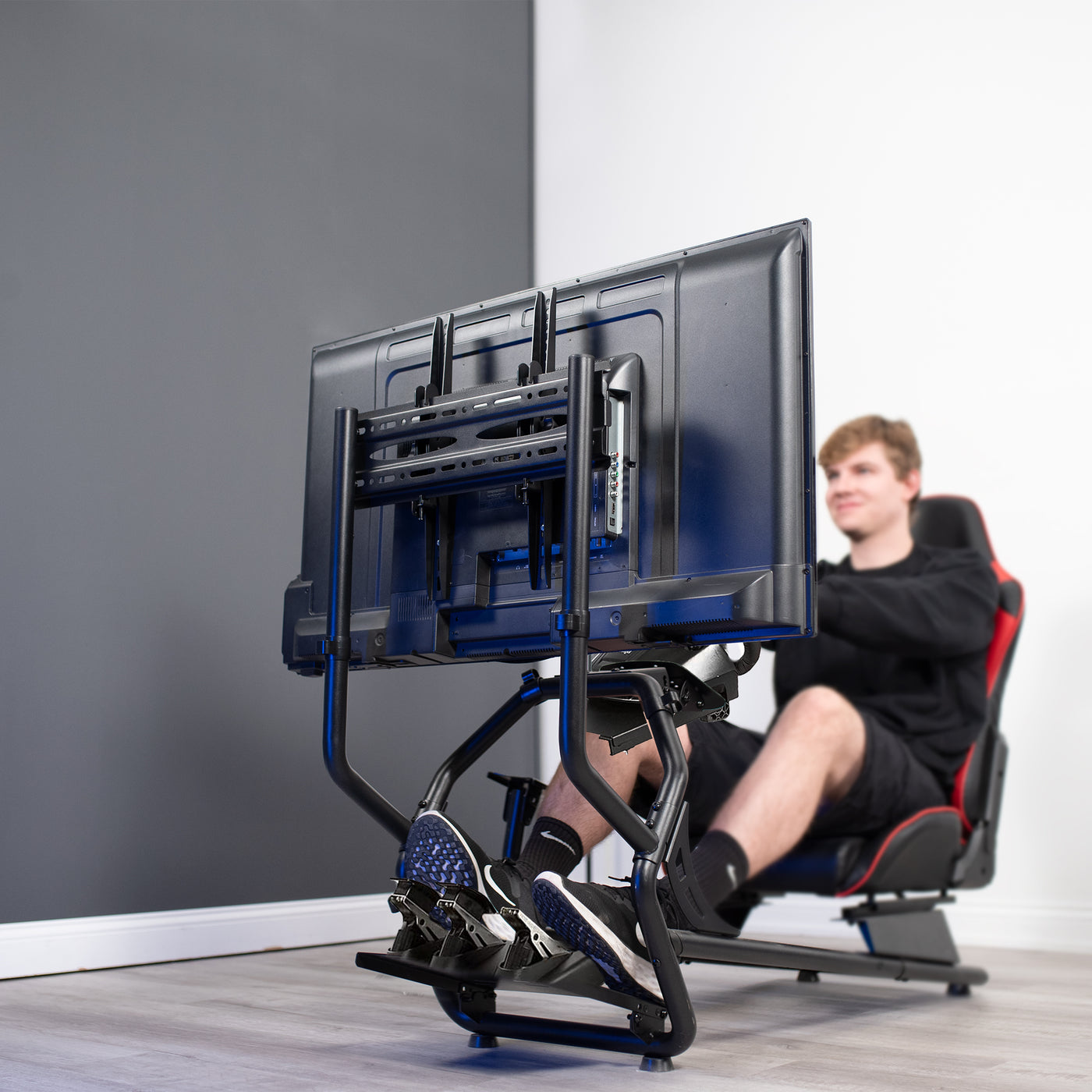 A person at a race gaming setup in the comfort of a home.