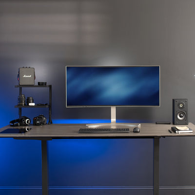 Office desk top with large curved monitor and dual shelf desk mount.