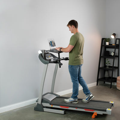 Simultaneously walk and work with a treadmill laptop riser.