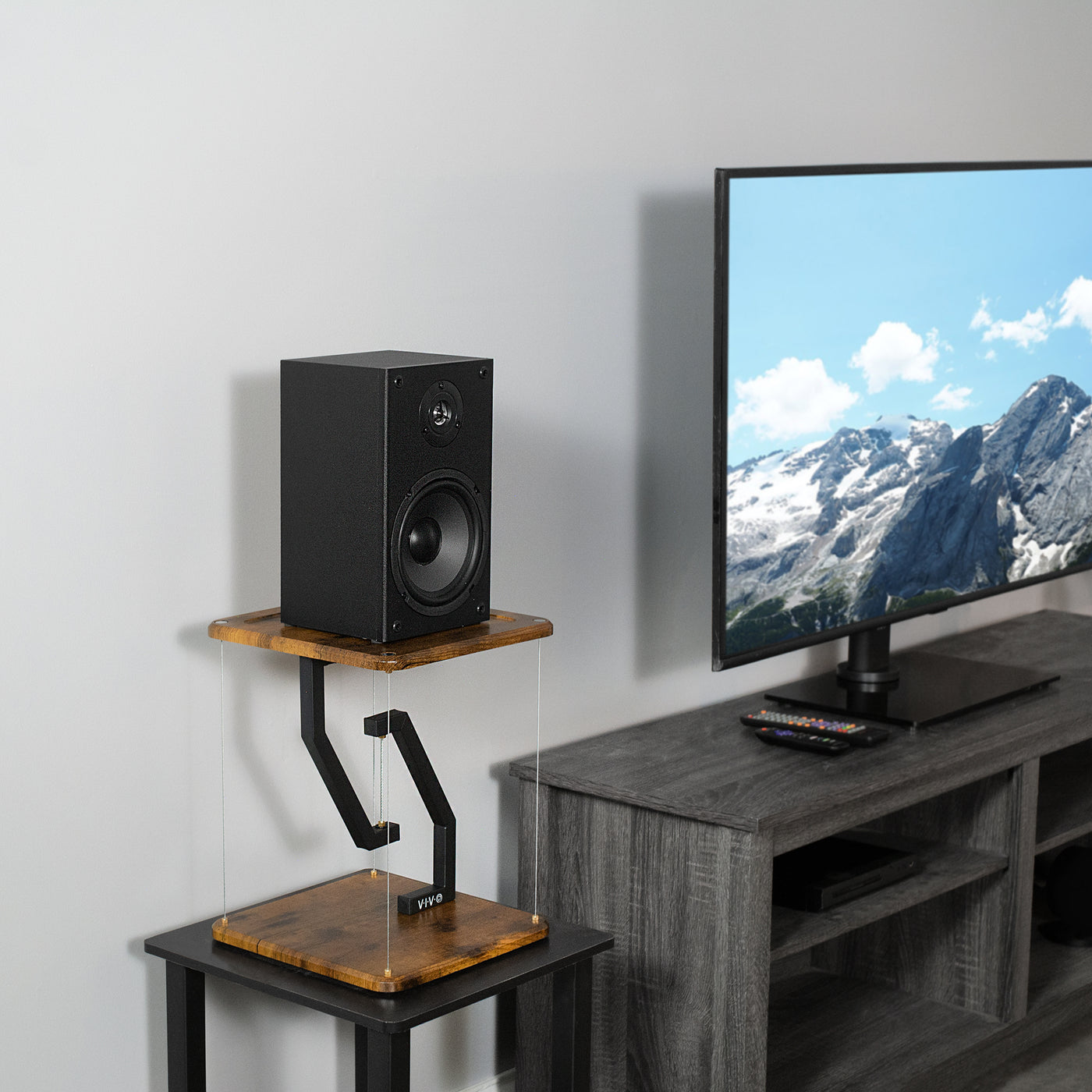 Modern TV space with surround sound speakers on anti-gravity floating stands.