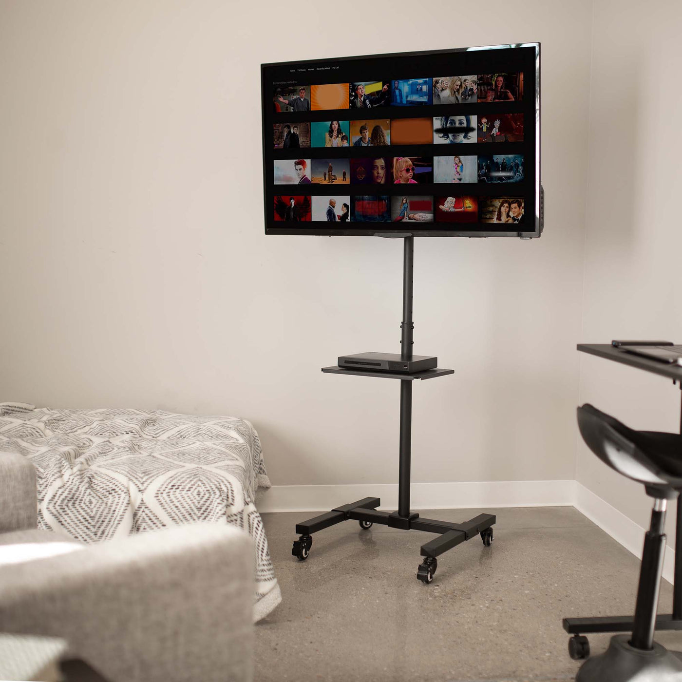 Sturdy mobile height adjustable TV cart with utility shelf and wheels.