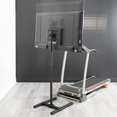A tall TV stand in front of a treadmill from VIVO.