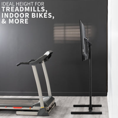 A minimalist black TV stand that fits behind treadmills, indoor bikes,  desks, shel, and more.