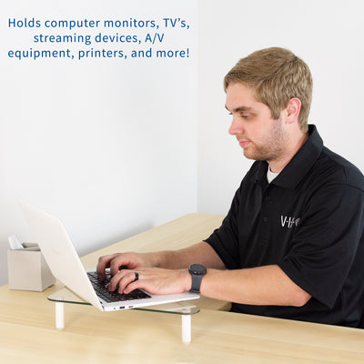 Triangle glass tabletop monitor riser for comfortable viewing.