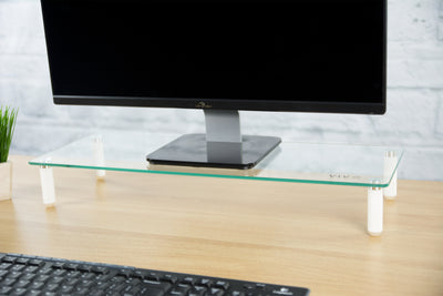 Sturdy glass tabletop monitor riser for comfortable viewing.