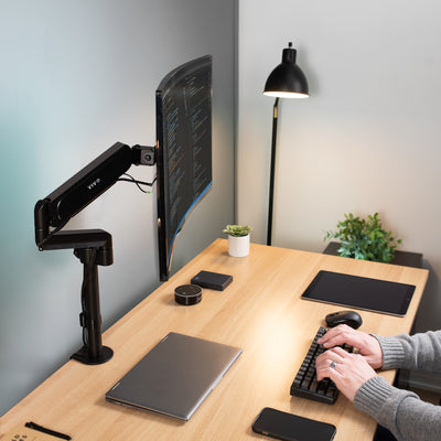 Securely support your monitor with a clamp on a pneumatic arm mount.
