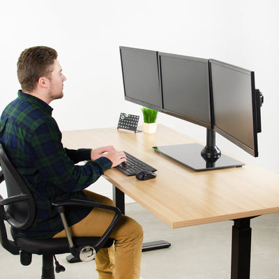 Sturdy height adjustable triple monitor desk stand.