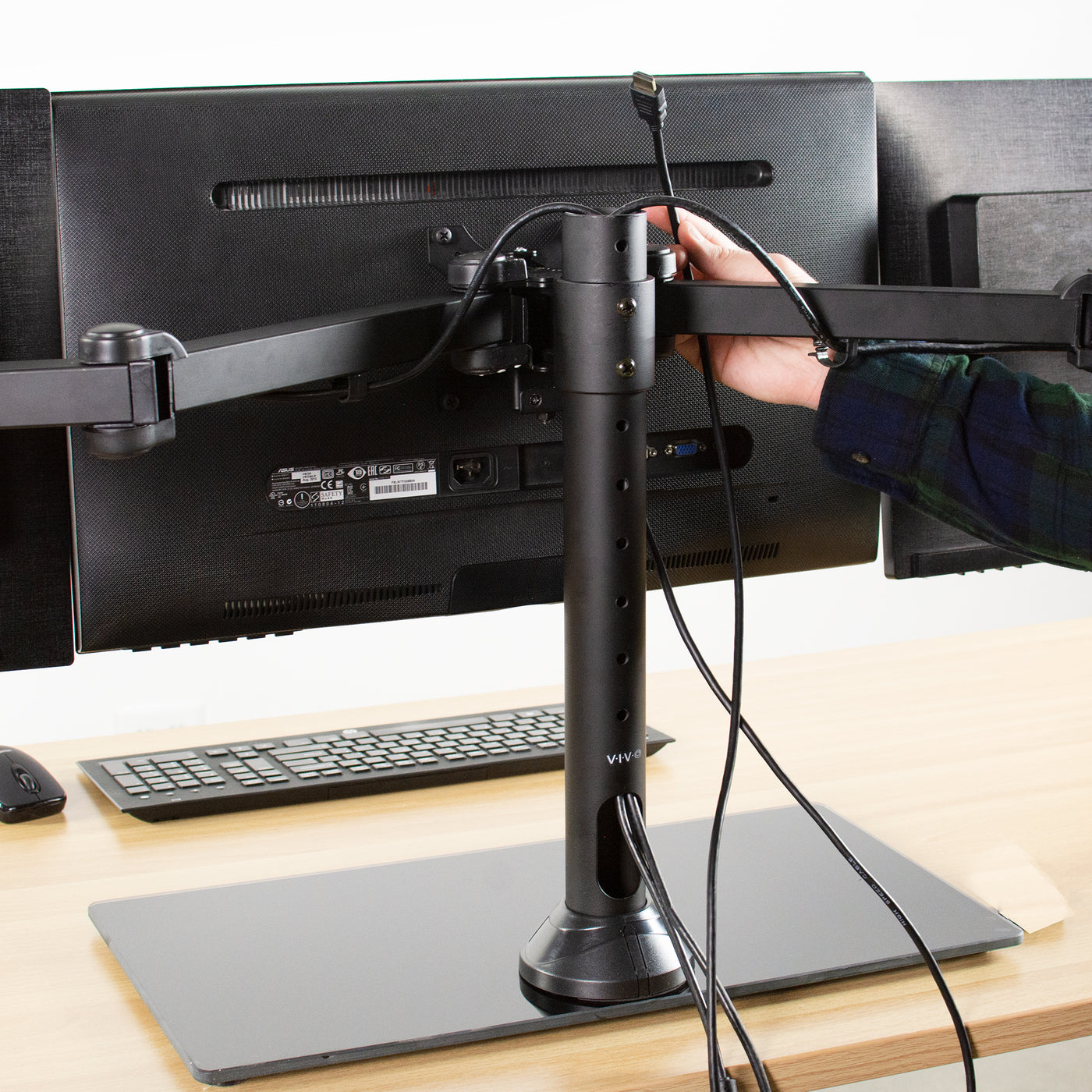 Sturdy height adjustable triple monitor desk stand.