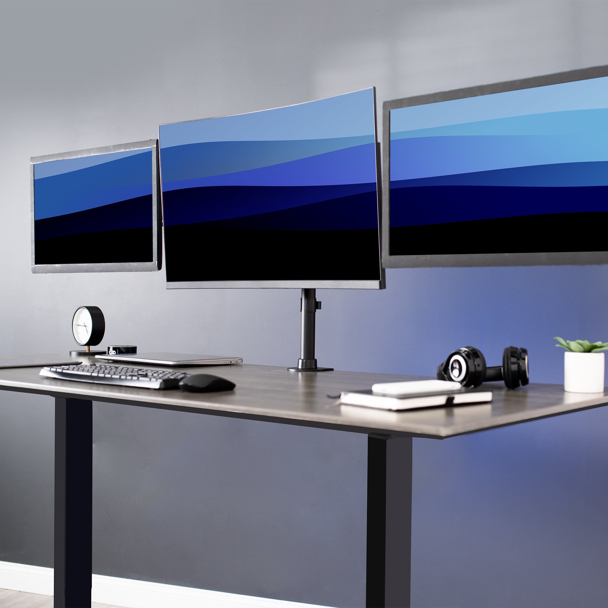 Sturdy height adjustable triple monitor desk mount.