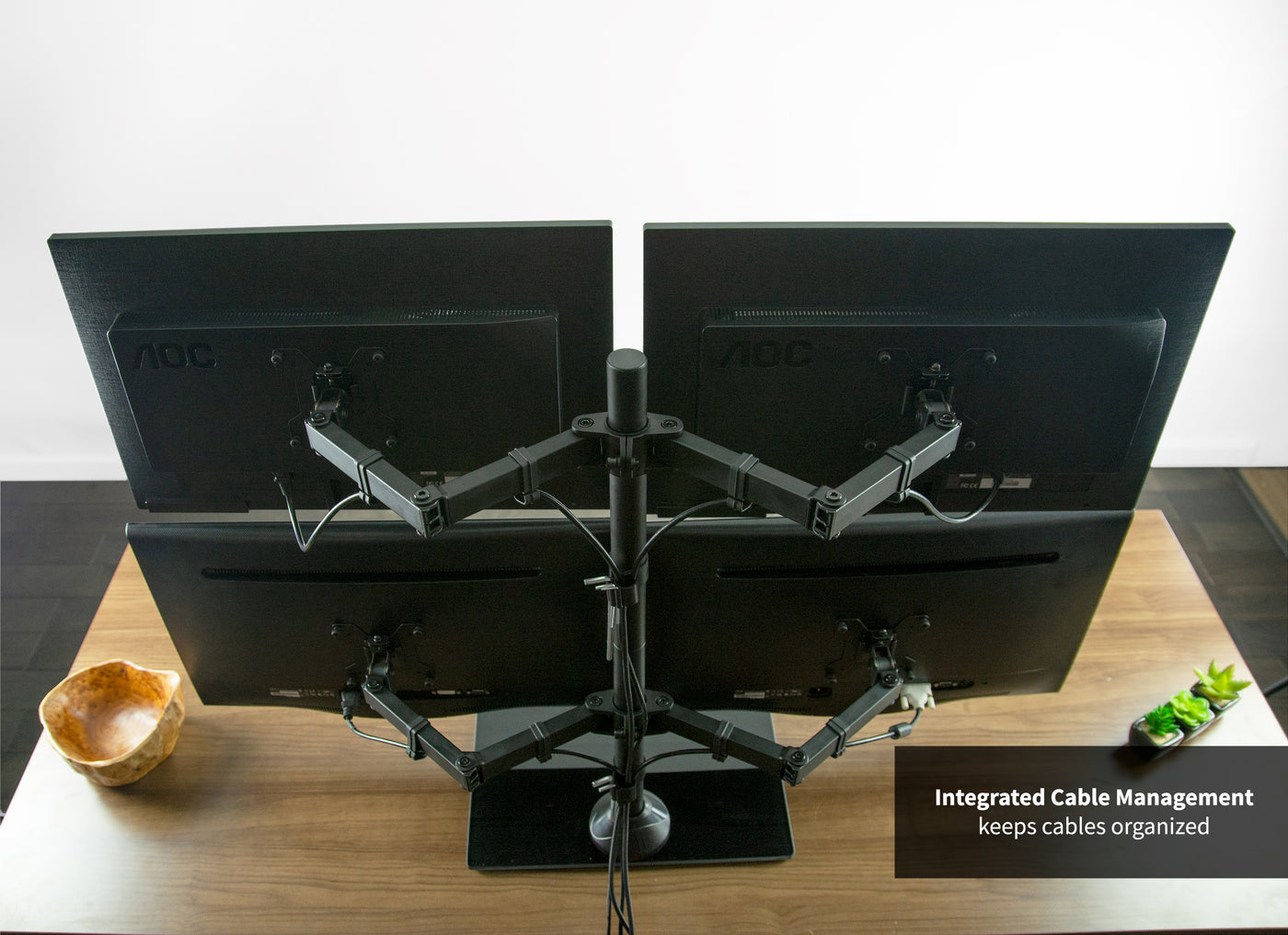 Sturdy height adjustable quad monitor desk stand with integrated cable management.