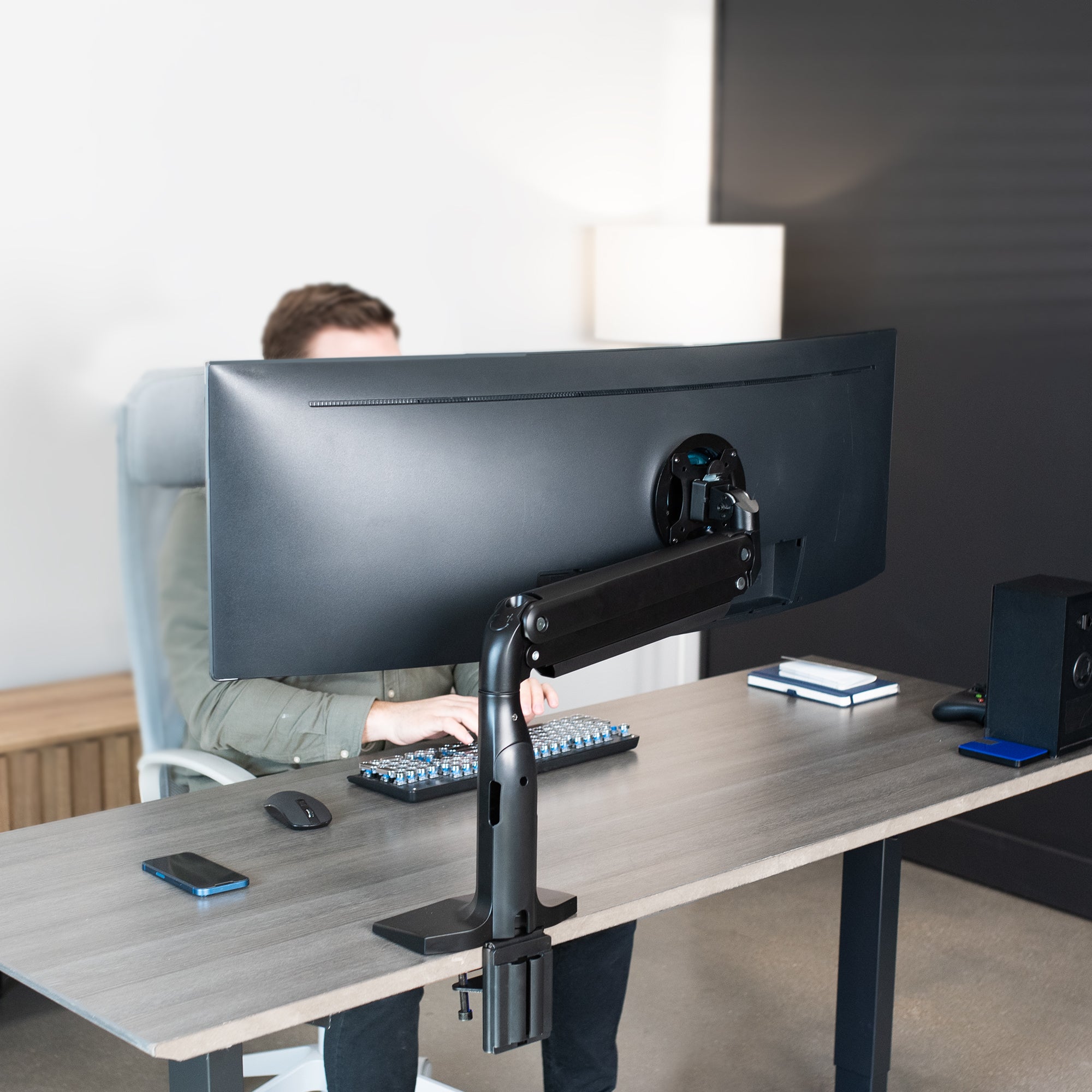 Ergonomic pneumatic arm with mounted ultrawide monitor.